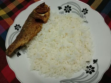 white colored Rice stock and fish on plate