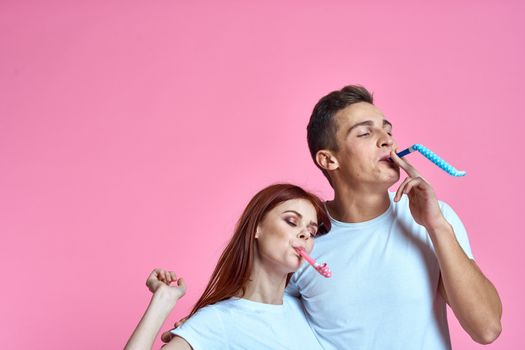 enamored man and woman hugging each other on a pink background cropped with Copy Space family portrait. High quality photo