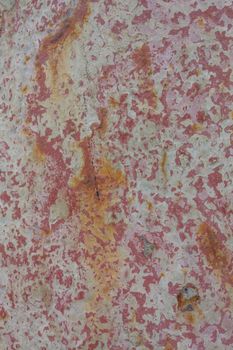 View of a sheet of metal with peeled paint. Background, texture