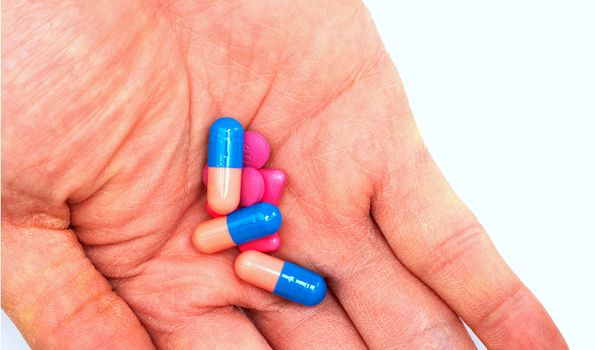 Hand holded medicines before take in oral in drug consumption concept,closed up