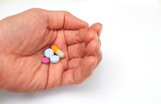 Hand holded medical pills before  oral take in medical healthcare consumption concept with copy space