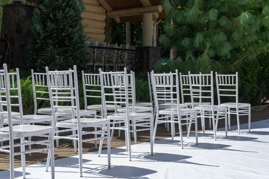 White wooden chairs. Wedding ceremony. Marriage registration.