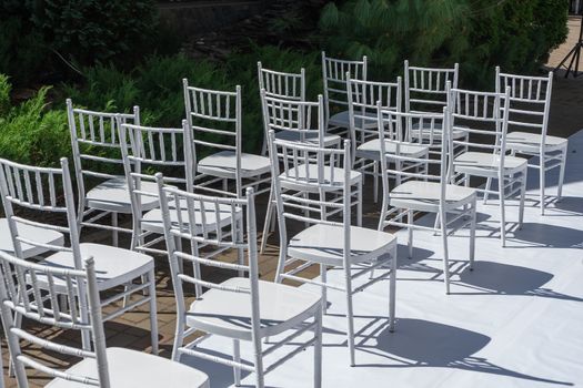 White wooden chairs for festive events. Wedding ceremony. Marriage registration.