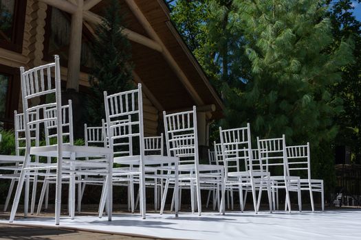 White wooden chairs for festive events. Wedding ceremony. Marriage registration.