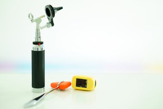 light Otoscope ,Hammer jerk and digital Oxymeter on blur background.jpg