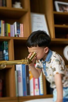 kid or boy use telescope indoors
