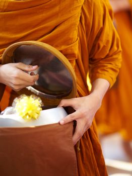 monk is offered food by buddist
