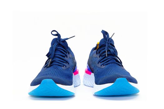 Pairs of blue sport shoes for running on white background