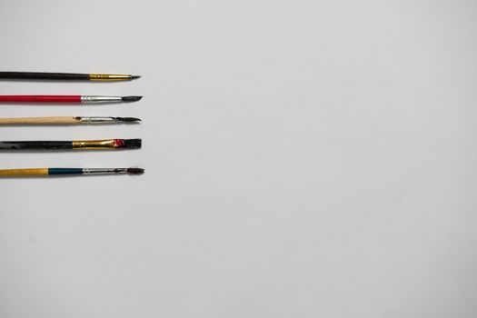 Paper of art work and color brushes,top view