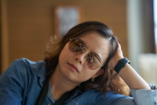 portrait of woman wear sunglasses in relax pose with wrist watch