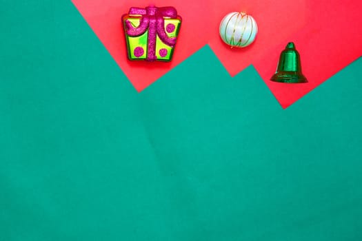 present box ,bauble and green ring on red and green background with copy space for new year and christmas time