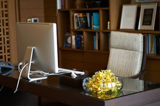 Room office of Manager or headmaster include computer armchair vase.
