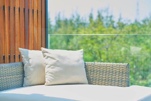 sofa with pillows in sunlight ,outdoors