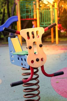 see saw toy in public playground in park on playground background