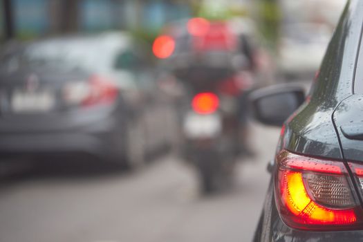 Taillight or rear lamp of car on blur traffic street view background