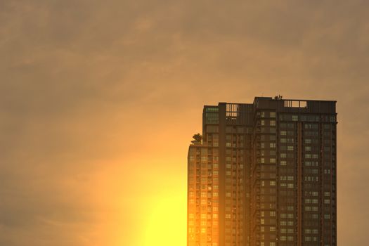 tall building on dawn sky background with sunlight