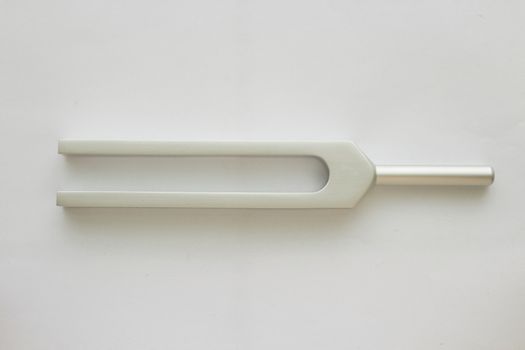 Tuning fork for ear test of ENT doctor or sound wave maker on white background