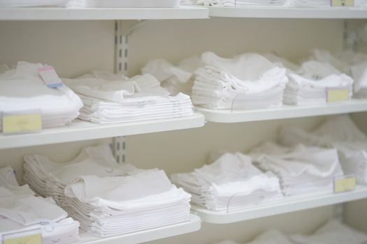 White clothes in shelves for sale
