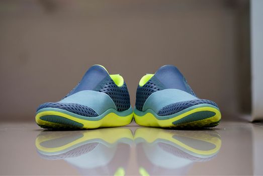 woman running shoes without string on blur background with reflection