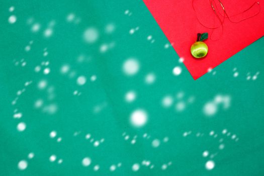 yellow fruit on red and green background with copy space for new year and christmas time with snow fall