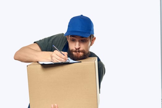 Man in working uniform box delivery loader courier light background. High quality photo