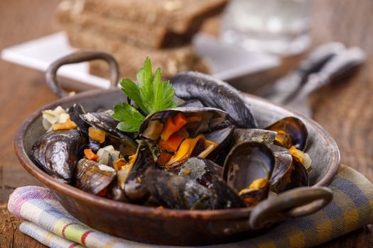 cooked mussels on dark wood