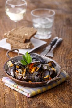 cooked mussels on dark wood