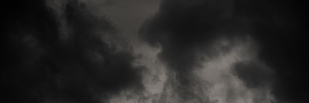 Panoramic view of dramatic thunderstorm clouds in dusk sky during rain. Natural cloudiness weather background. Soft focus, motion blur sky natural meteorology cloudscape.