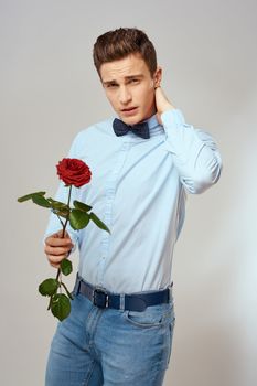 romantic man with red rose and light shirt pants suit. High quality photo