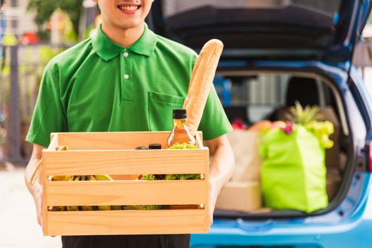 Asian delivery man grocery prepare service giving fresh vegetables food and fruit full in wooden basket on back car to send woman customer at door home after pandemic coronavirus, Back to new normal