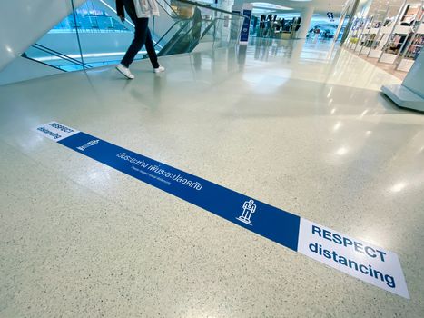 sign of respect distancing on floor in Central Embassy, Bangkok as pandemic influenza precautions procedure during Covid-19 situation