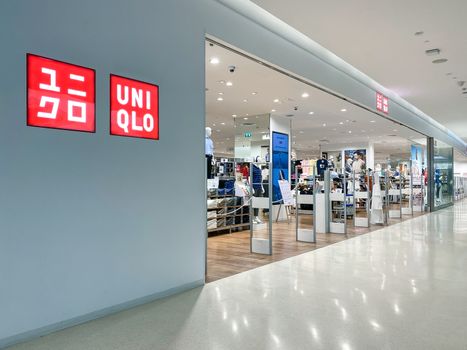 Uniqlo logo in front of the store, a Japanese casual wear designer, manufacturer and retailer, design of logo is flat and bold