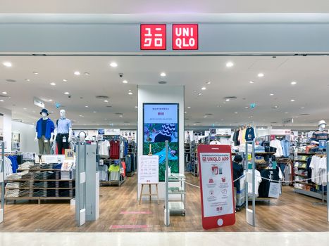 Uniqlo logo in front of the store, a Japanese casual wear designer, manufacturer and retailer, design of logo is flat and bold