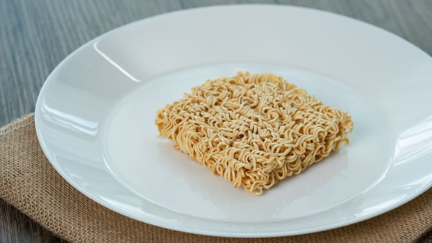Instant noodle on white plate background.