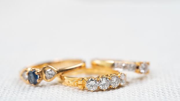 Group of diamond ring on white sack background.