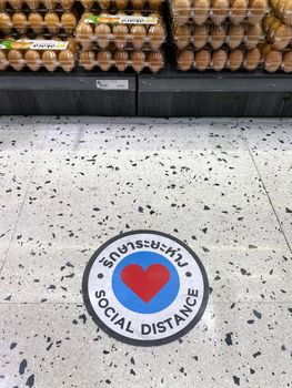 sign of social distance on floor in Gourmet Market of the EmQuartier, Bangkok as pandemic influenza precautions procedure during Covid-19 situation