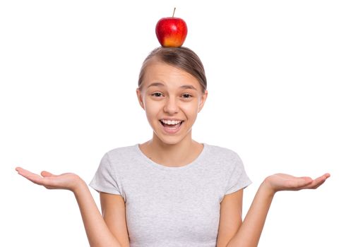 Happy beautiful young teen girl with apple on head, isolated on white background