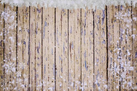 Vintage wood wall with snow. Christmas rustic backdrop, winter scene. Holiday card with wooden texture, snowflakes and copy space.