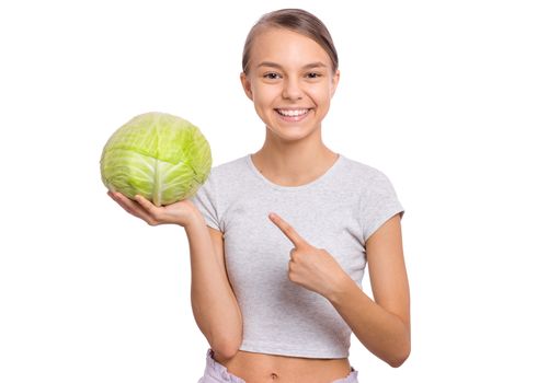 Beautiful young teen girl holding fresh green cabbage, isolated on white background