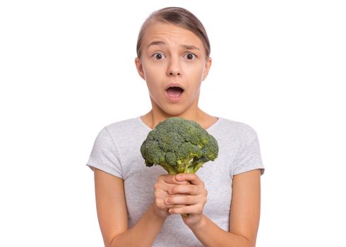 Happy beautiful young teen girl holding perfect product for dieting green broccoli, isolated on white background