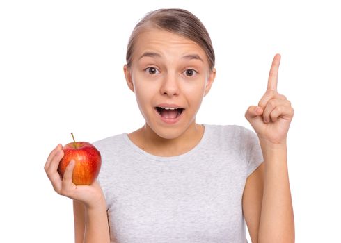 Happy beautiful young teen girl holds apple, isolated on white background