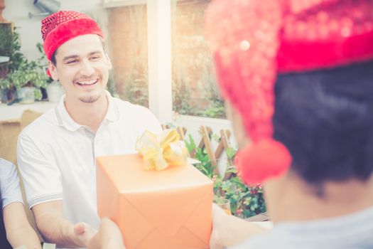 Asian group people man and woman giving gift box and celebration at party outdoor. group of friends social event with birthday achievement, festive concept.