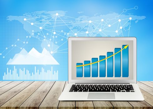 laptop on wood table office desktop, business chart and diagram with abstract background, computer analysis revenue data with finance of stock, buiness economy concept.