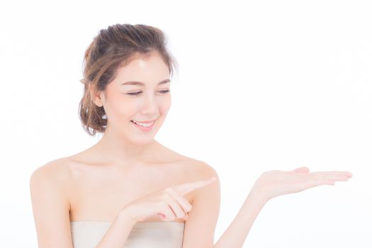 Asian beautiful young woman showing with healthy clean skin presenting something empty copy space on the hand isolated on white background, beauty concept.
