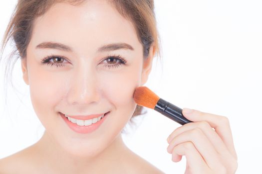 Beauty asian woman applying make up with brush of cheek isolated on white background, beautiful of girl holding blusher, skincare and cosmetic concept.