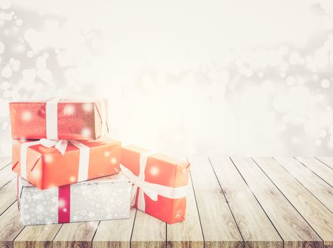 many gift box with ribbon on wood table top bokeh white background - using for christmas and new year or holiday other - celebration concept.