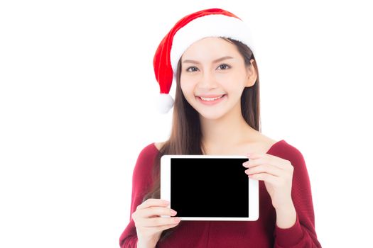 Asian young woman wear santa hat with digital tablet empty space, Beautiful girl showing tablet with season merry christmas and happy new year holiday, shopping online concept.