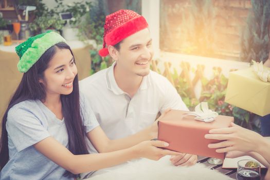 Asian group people man and woman giving gift box and celebration at party outdoor. group of friends social event with birthday achievement, festive concept.