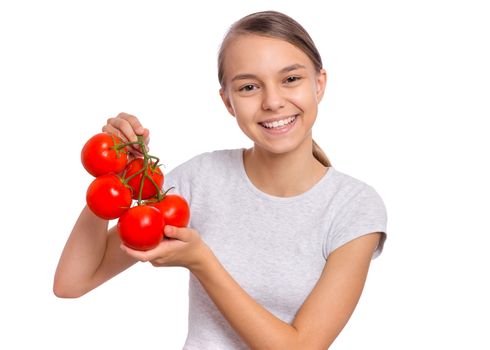 Beautiful young teen girl holding fresh tomatoes, isolated on white background