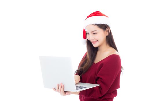 Portrait of beautiful asian young woman in santa hat using laptop computer with happy and smile isolated on a white background, season holiday concept.